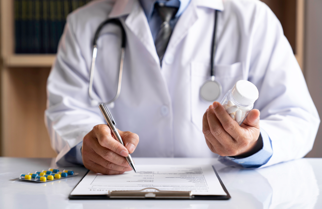 Prescriber completing a prescription beside a medication bottle