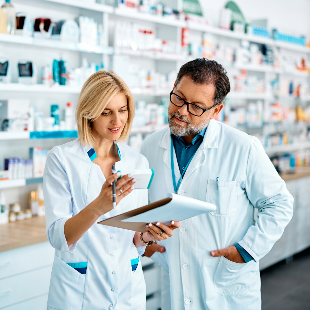 Two pharmacists reviewing a patient’s chart together